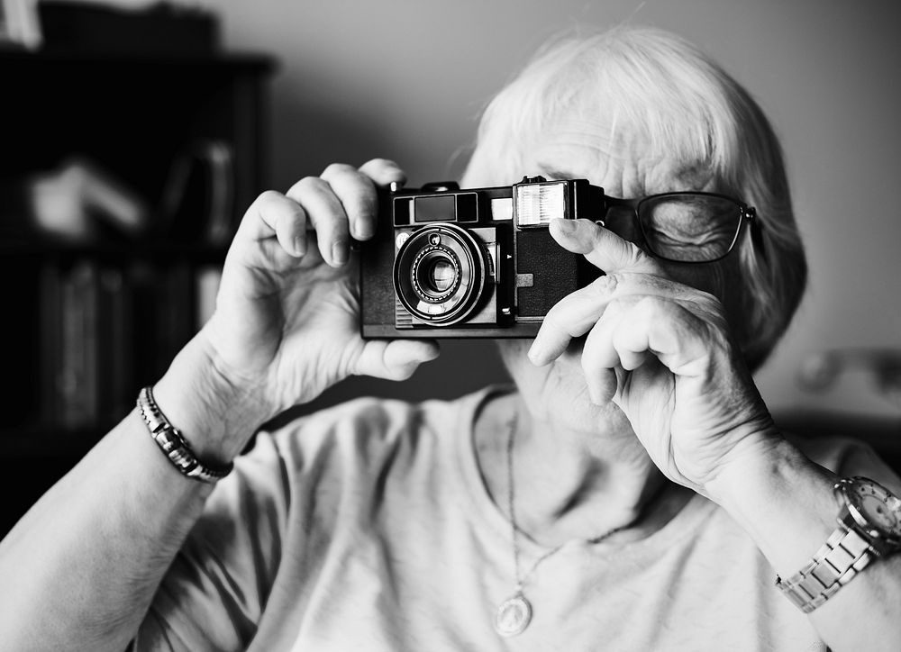 Senior woman taking a picture by camera