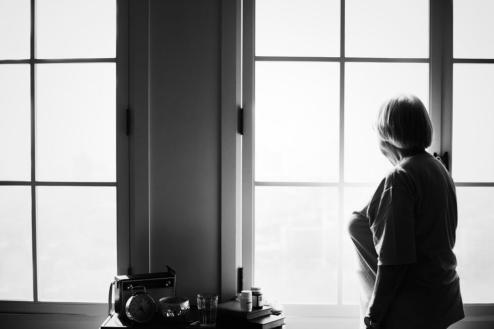 Senior woman standing alone at home