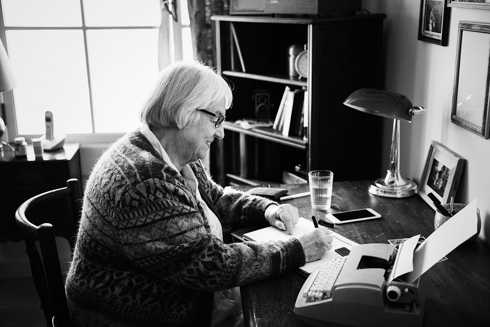 Senior woman writing on a paper