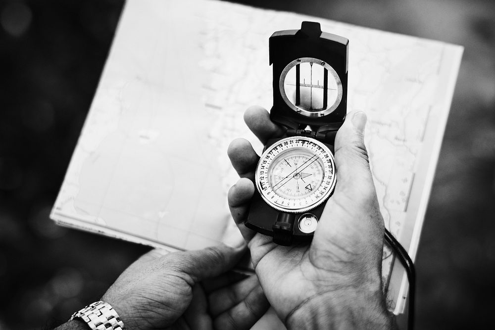 Man checking direction on a compass