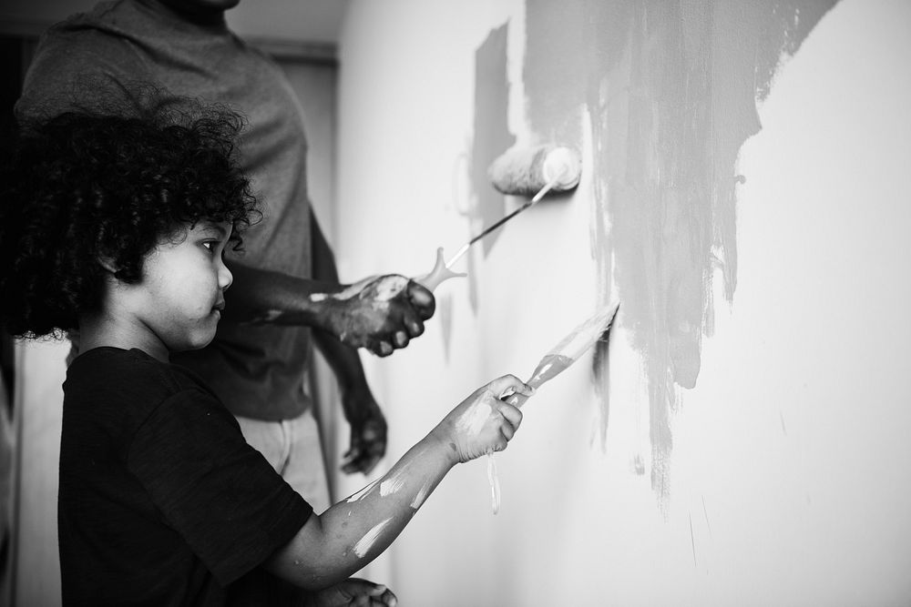 African family painting the house wall