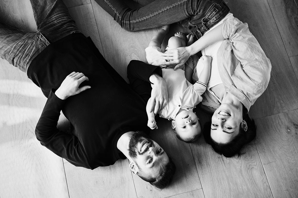 Family laying on thewooden floor