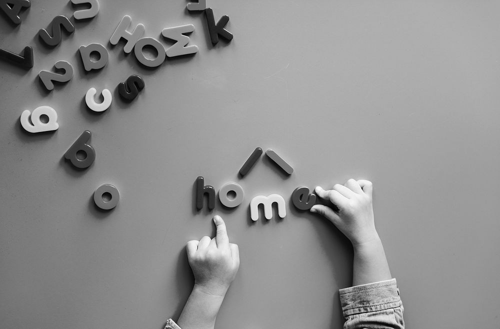 Kid playing with alphabet letters