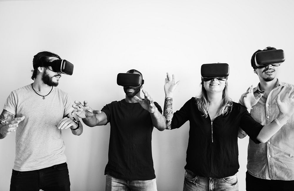 Group of friends experiencing virtual reality with VR headset