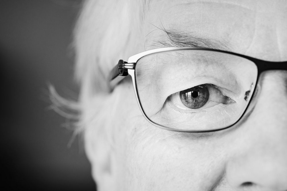 Portrait of elderly woman closeup on eyes wearing glasses