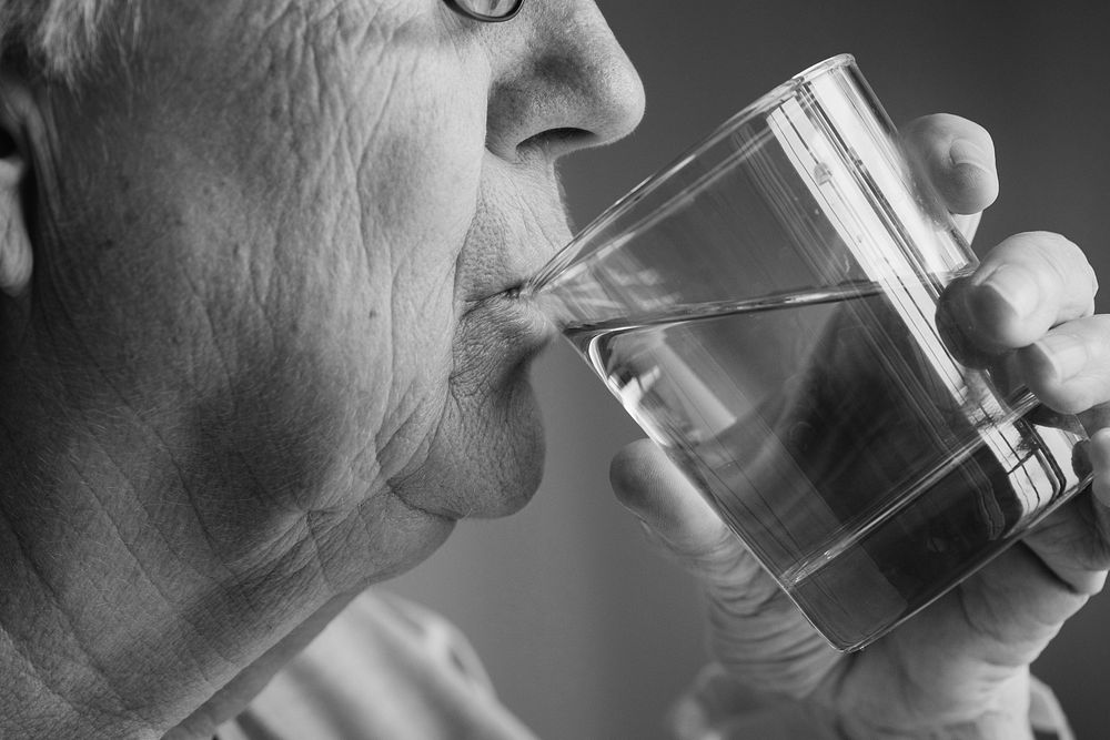 Side view of elderly woman drinking water