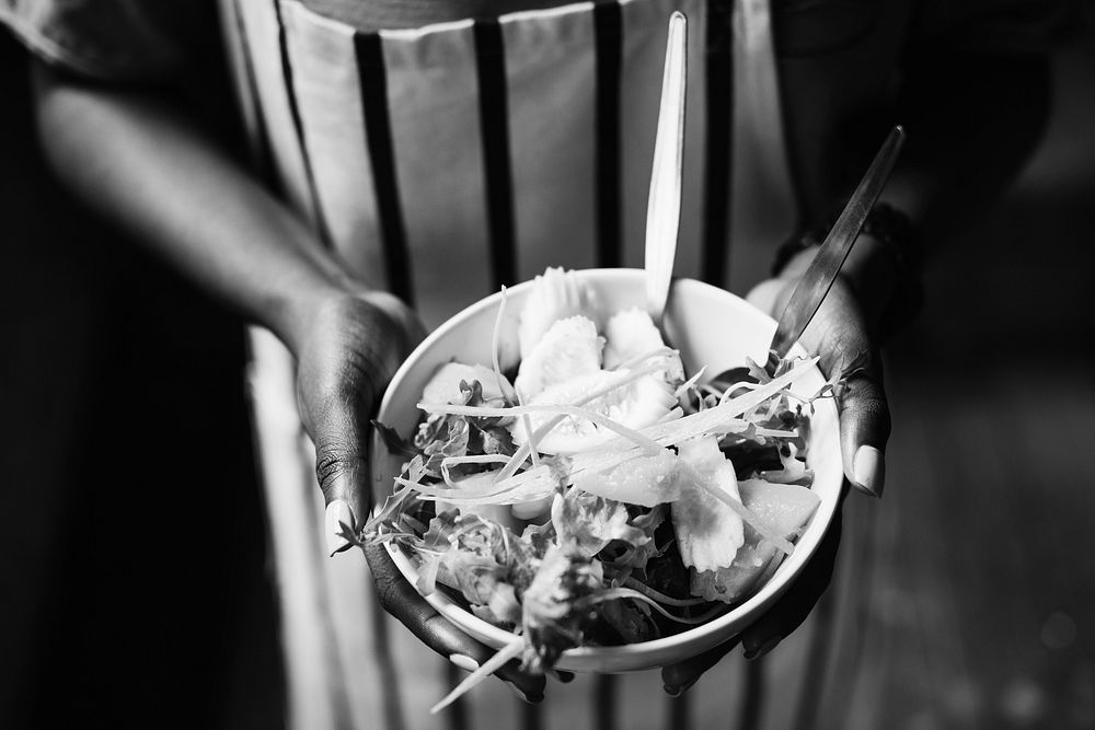 Black woman holding a salad bowl