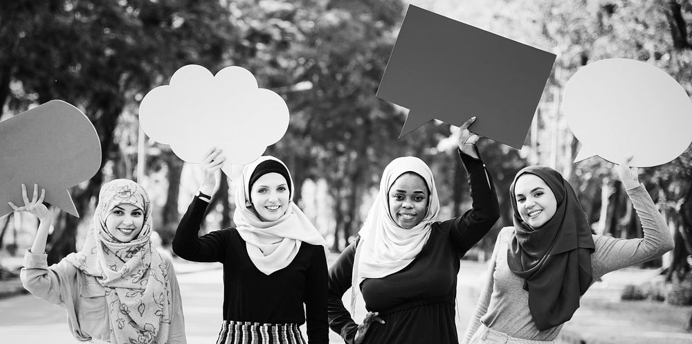 Muslim women holding speech bubbles