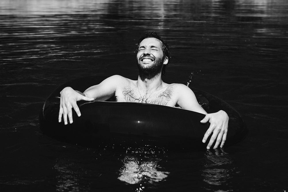 Happy man floating around in the water