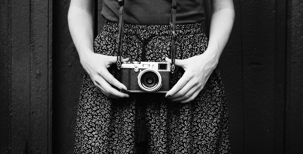 Solo female traveler holding a camera