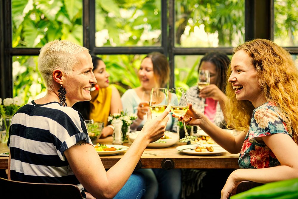 Female friends celebrating with wine