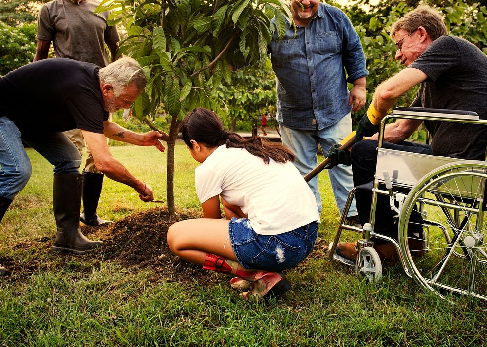 Group of people planting a new tree