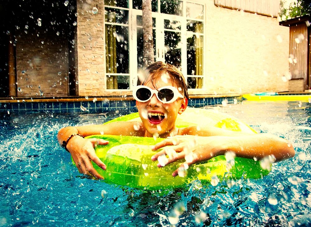 Boy enjoying summertime in a swimming pool