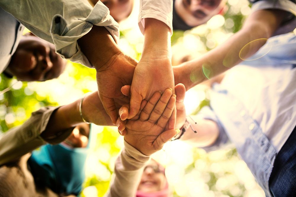 Group of diverse friends stacking hands