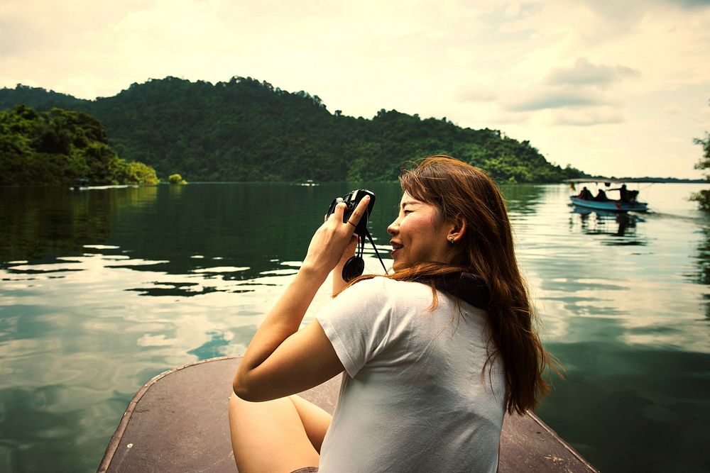 Asian woman taking photos of her surroundings