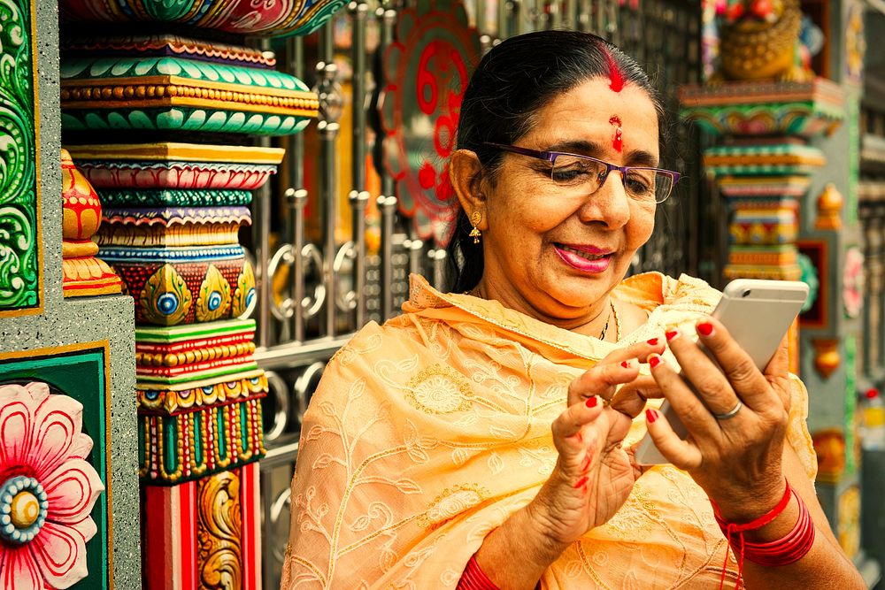 Indian woman texting on her smartphone