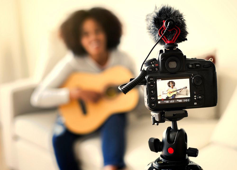 Female vlogger recording a music video