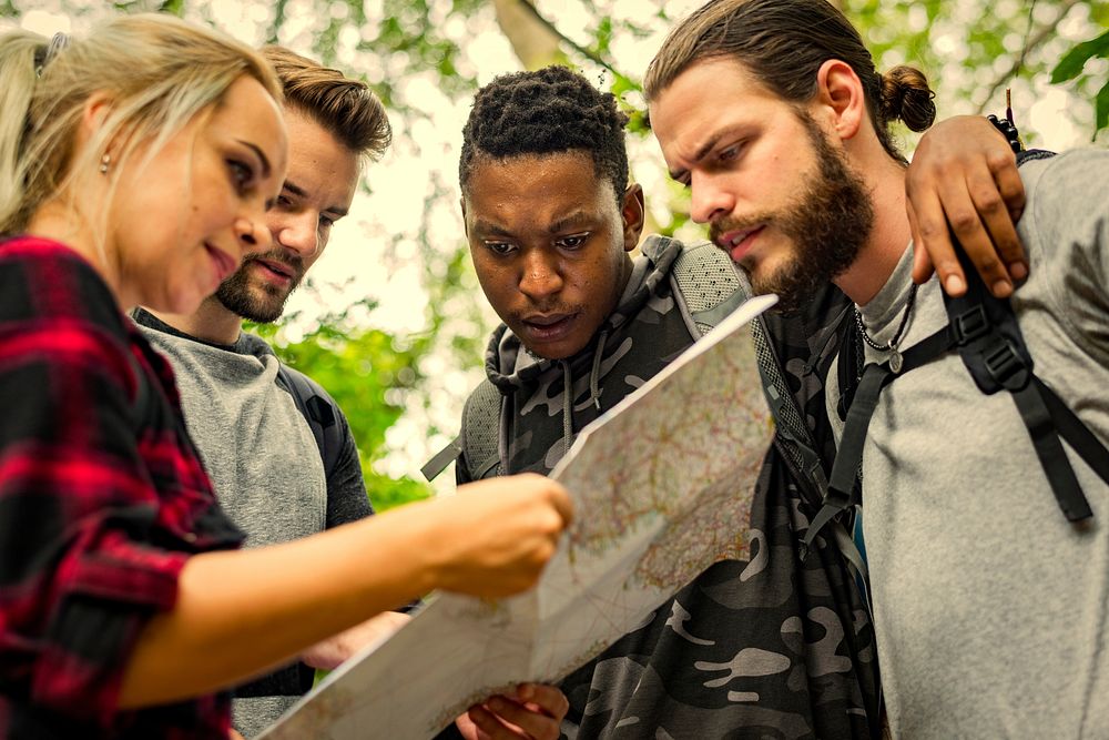 Friends following a map in the forest