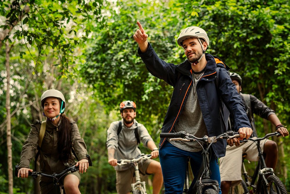 Group of friends riding mountain bike in the forest