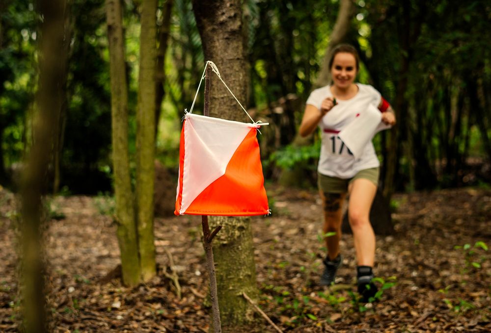 Woman racing to an orienteering check point