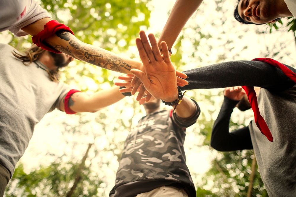 Group of hikers stacking hands