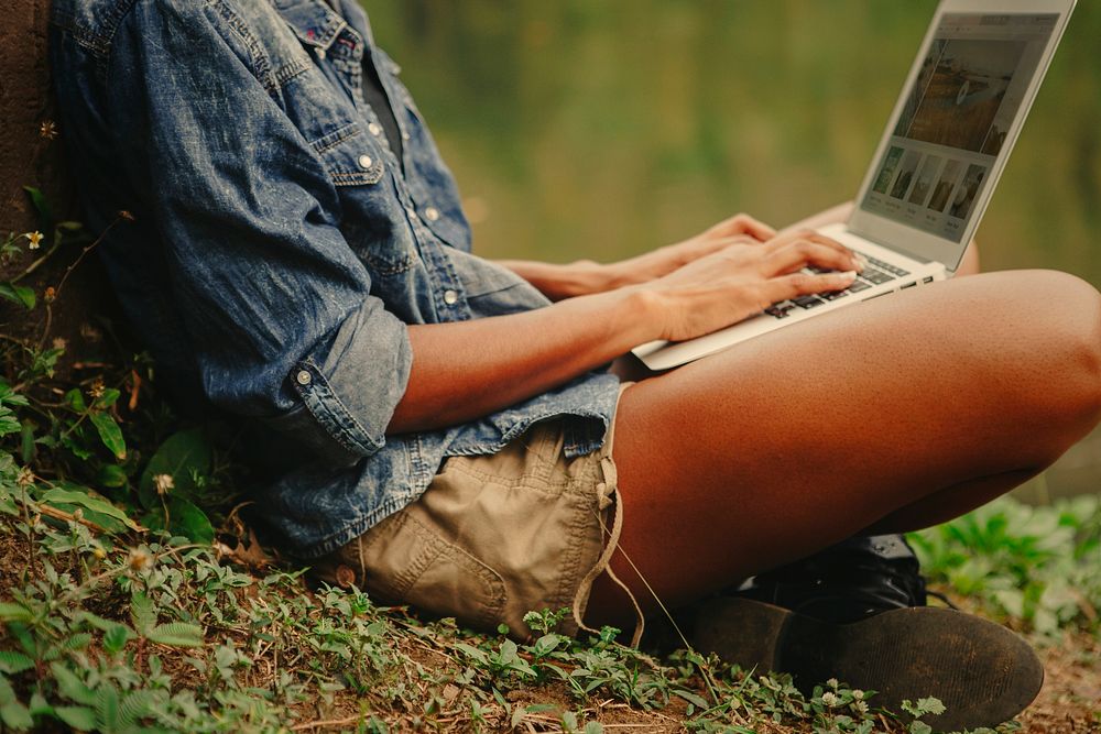 Woman working on a laptop in the nature