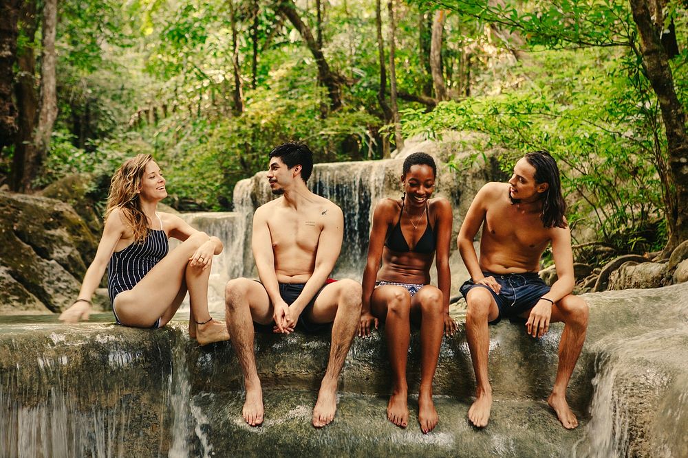Friends hanging out at a waterfall