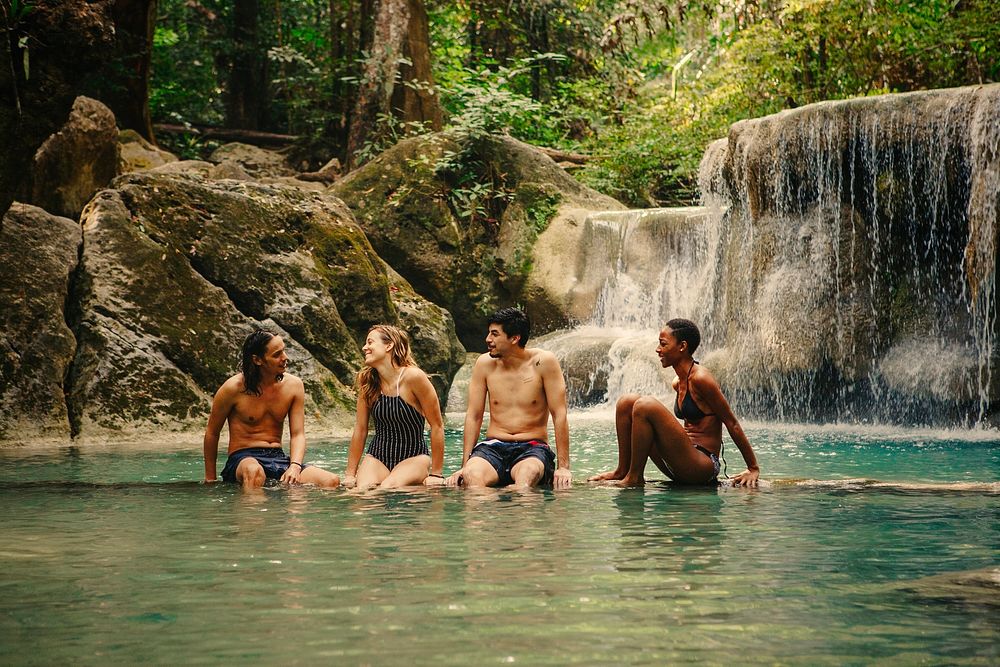 Friends hanging out at a waterfall