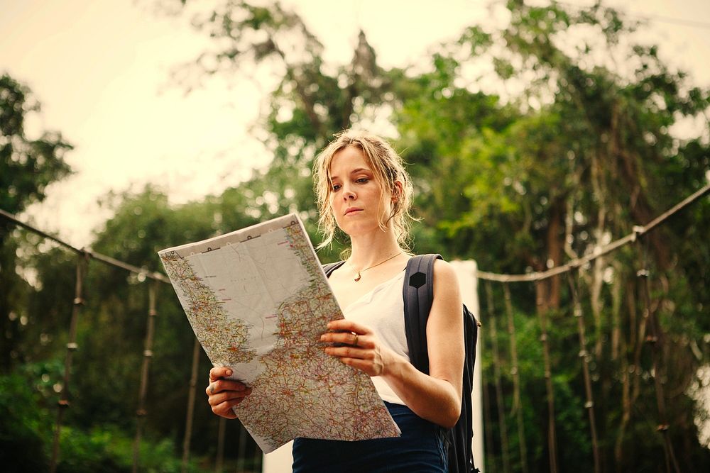 Woman following a map in nature