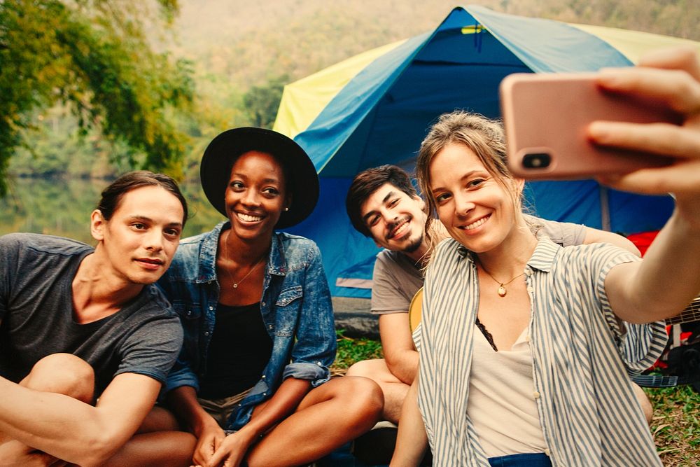 Group of friends taking a selfie at a campsite