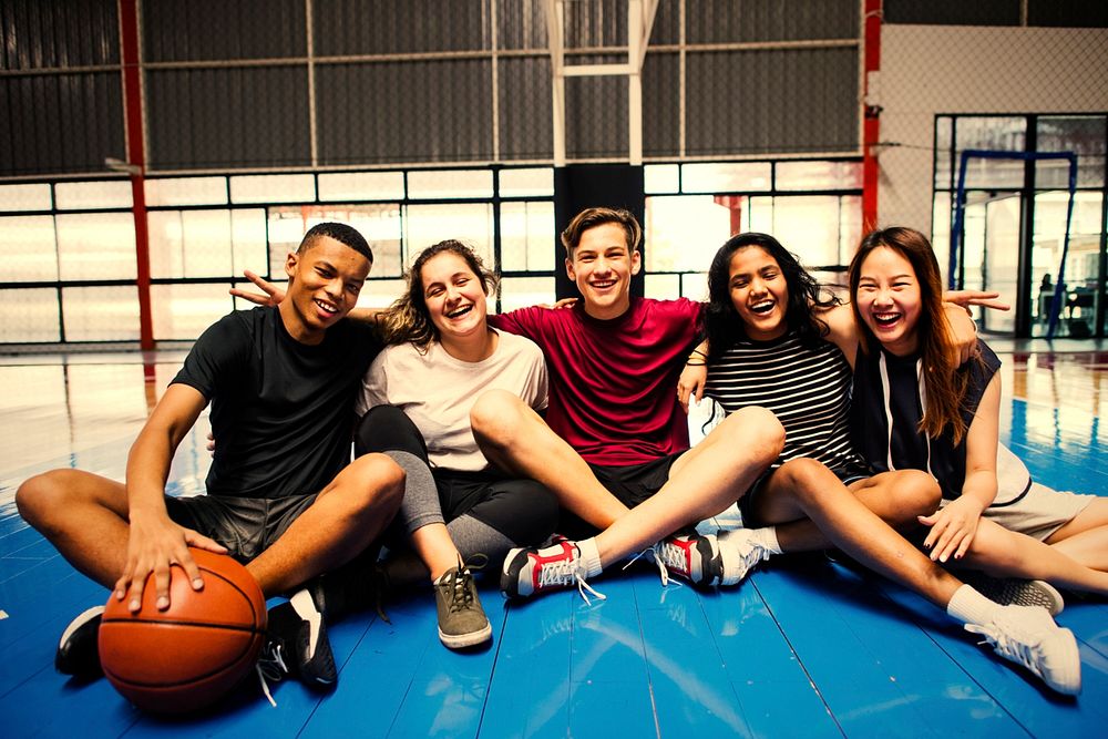 Active friends hanging out at a basketball court