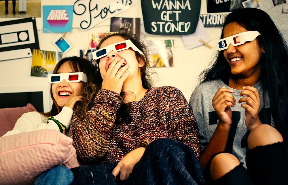 Teenage girls wearing 3d movie glasses