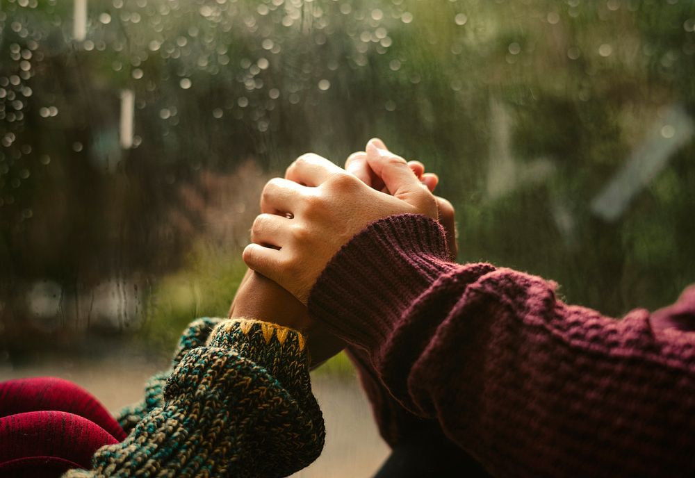 Couple holding hands on a rainy day