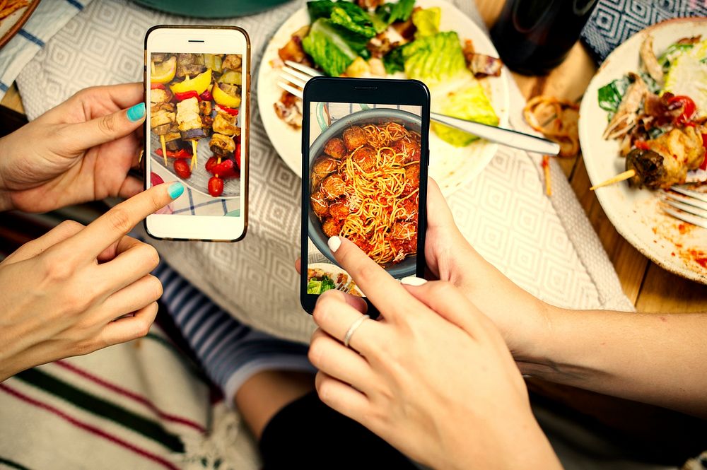 People sharing food photos on mobile phones