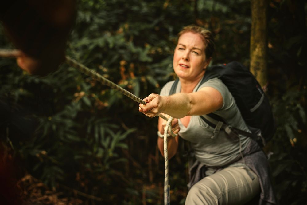 Woman climbing up a rope