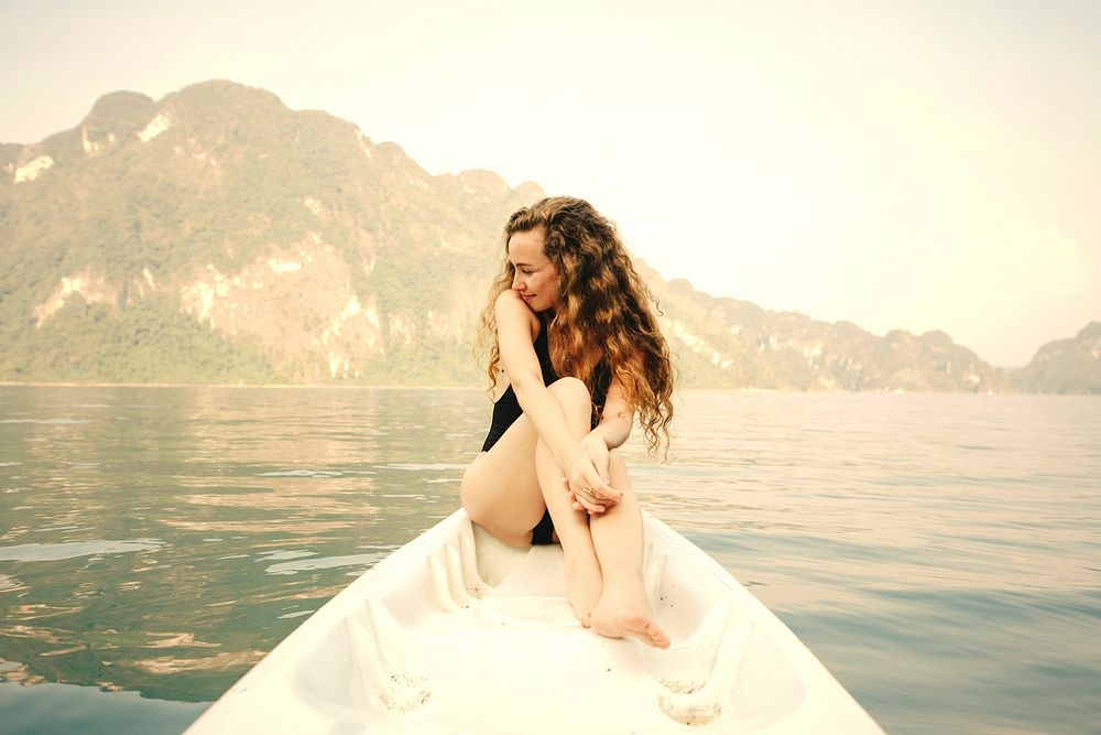 Woman relaxing on a canoe at a lake