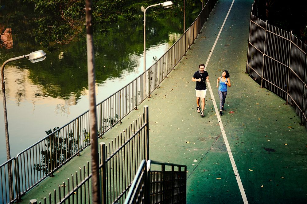 Couple running on a green lane