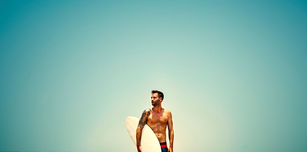 Fit man with a surf board