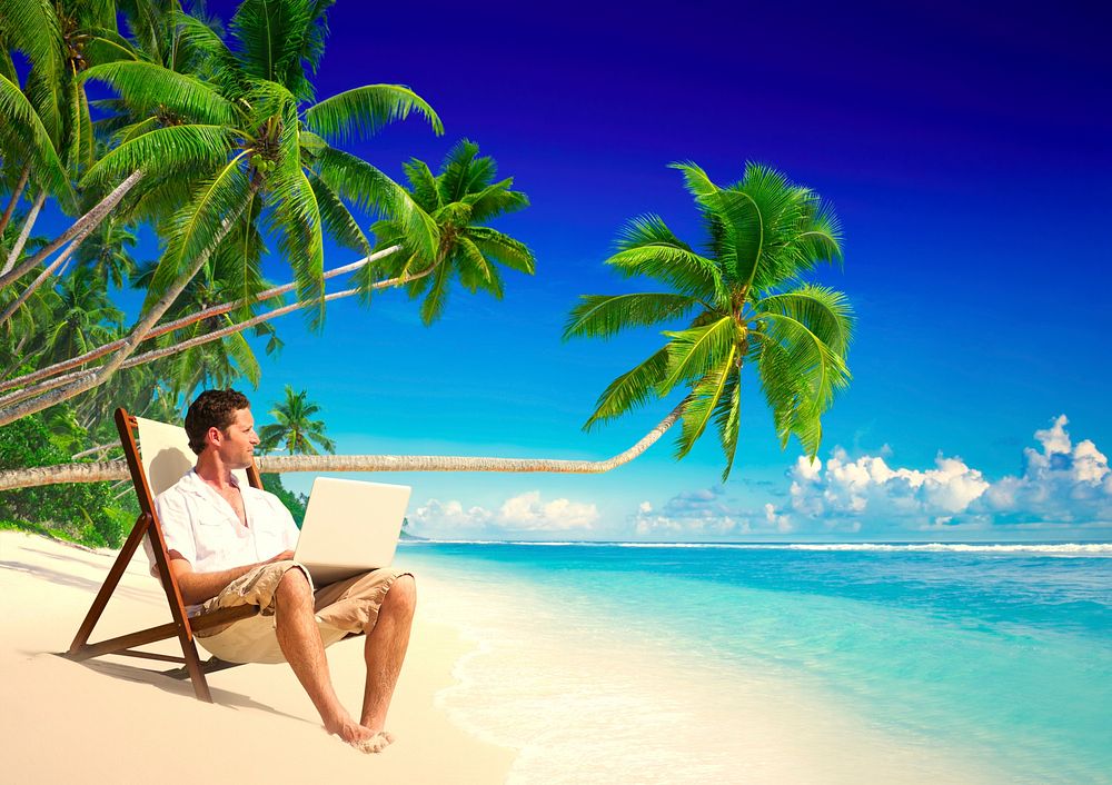 Businessman working remotely from a beach