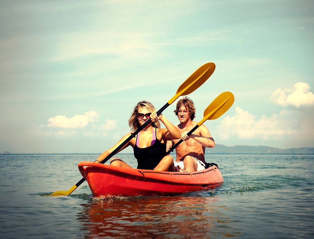 Couple paddling in a red kayak