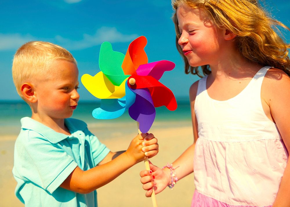 Brother and sister playing with a pinwheel