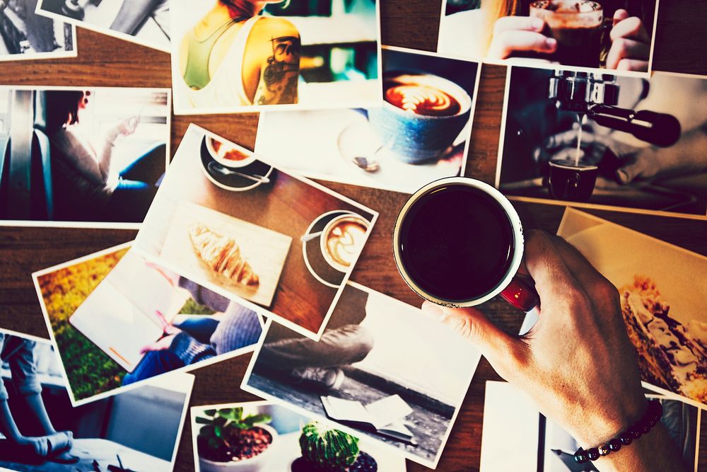 Coffee and printed photographs on a table