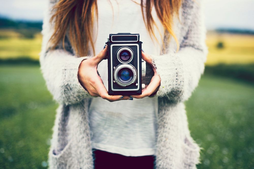 Woman holding a vintage film camera