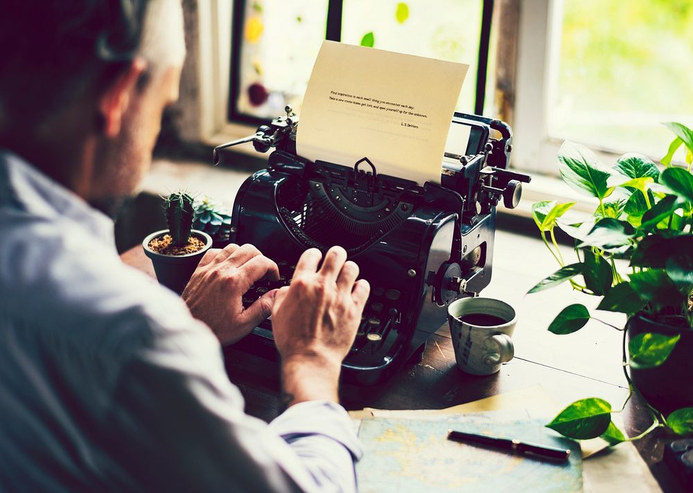 Man typing on a vintage typewriter