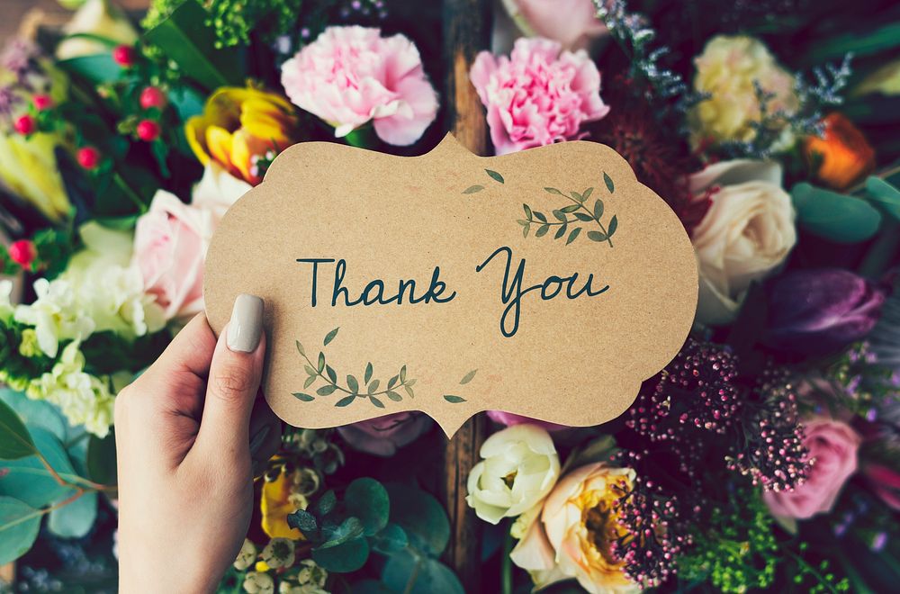 Handwritten thank you card with floral background