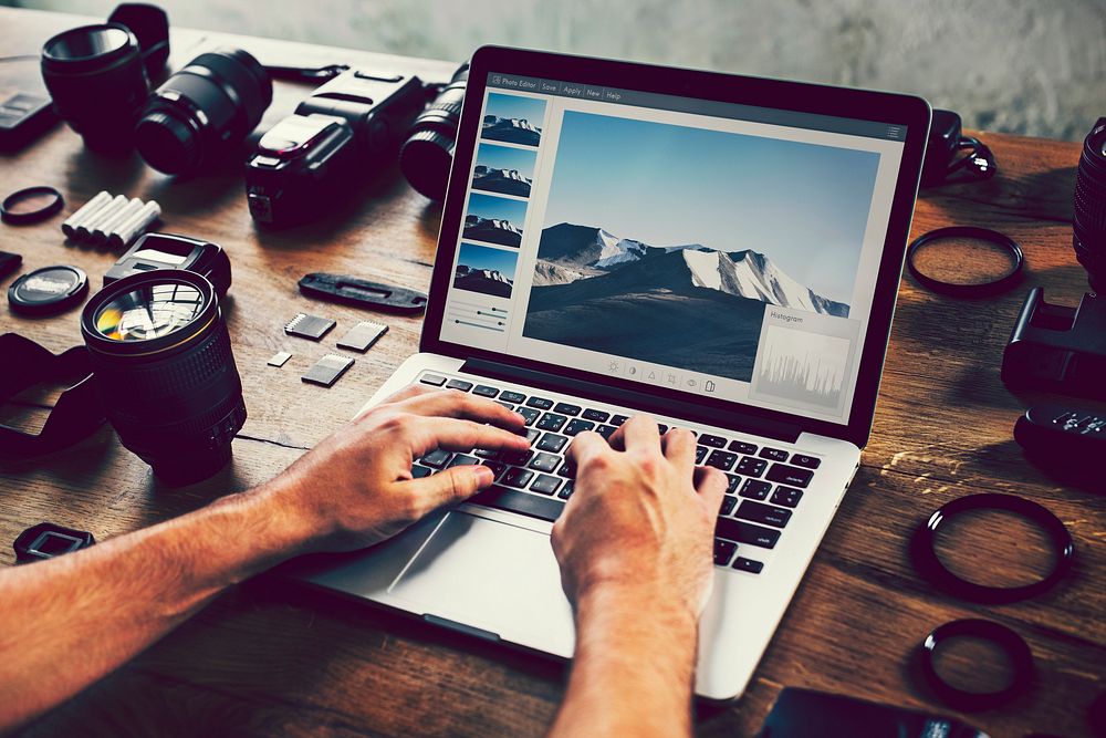 Photographer editing photos on a laptop