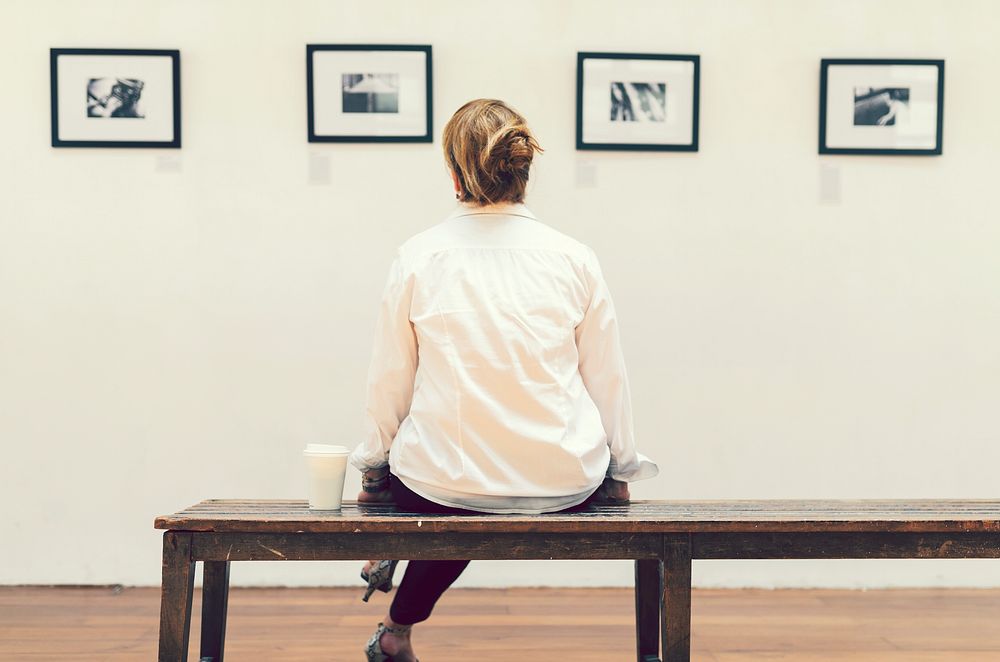Woman sitting in an exhibition