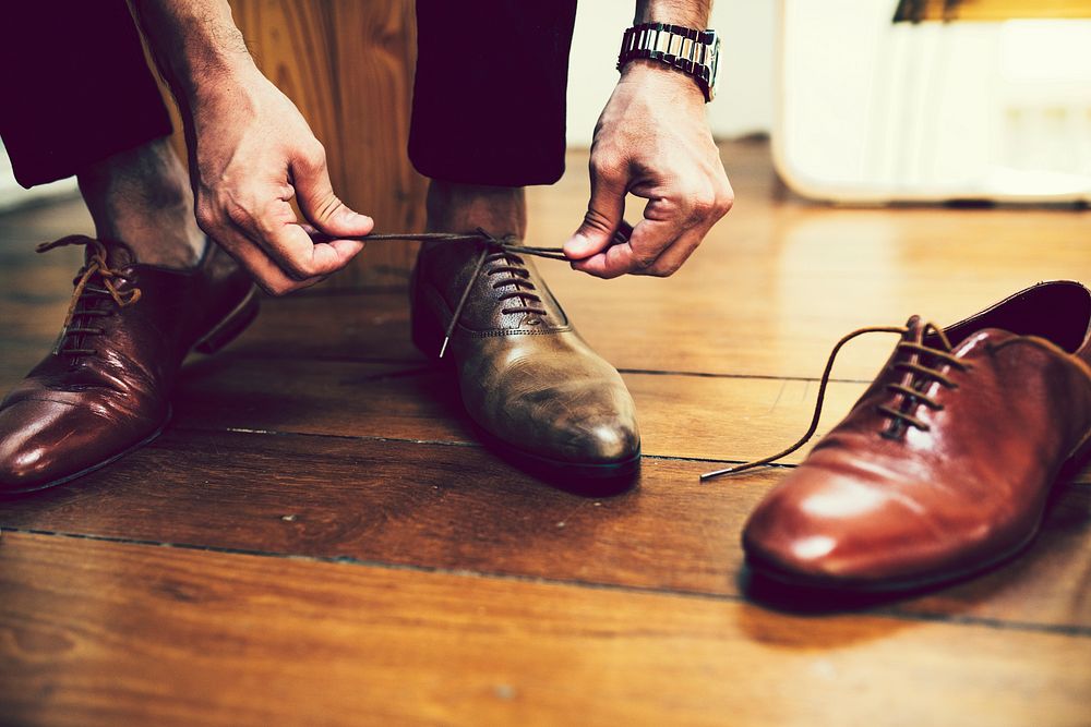 Man tying a knot on his shoes