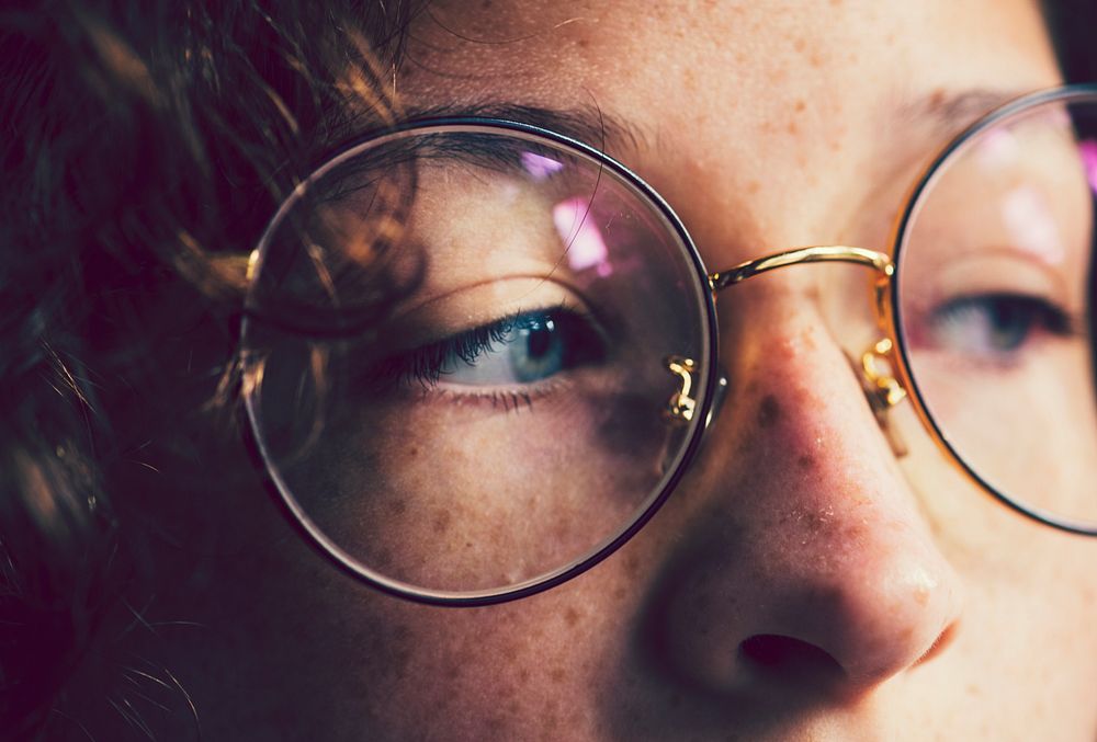 Girl with freckles wearing glasses