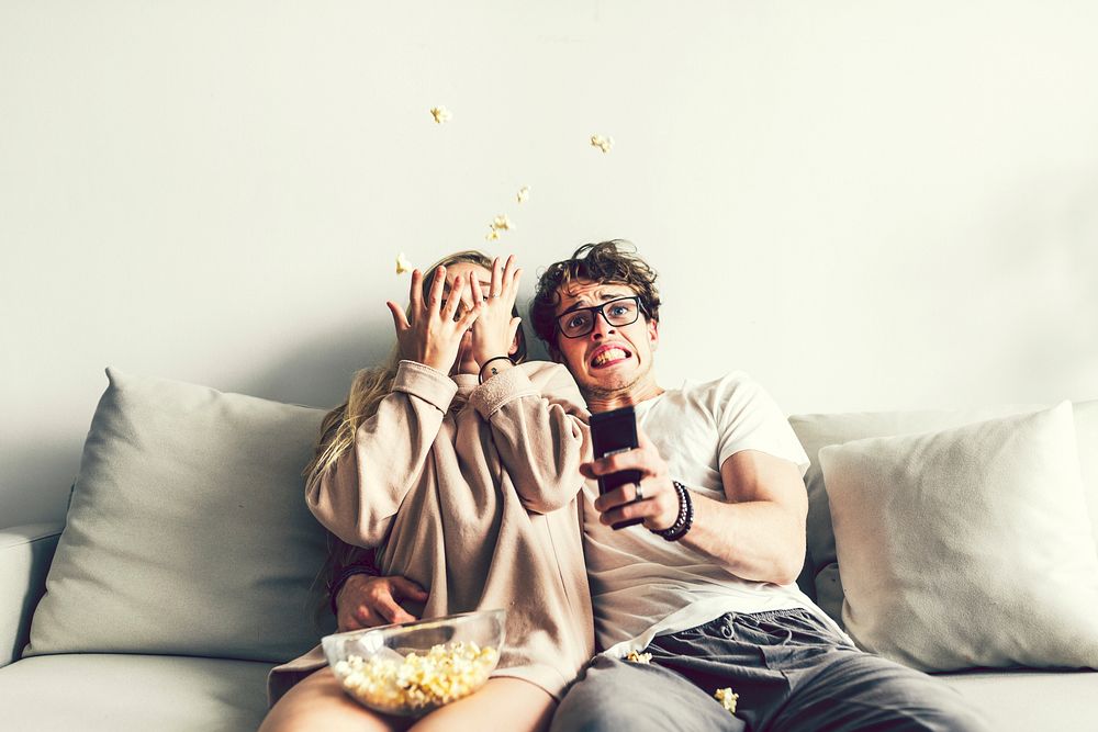 Couple watching a movie on the sofa